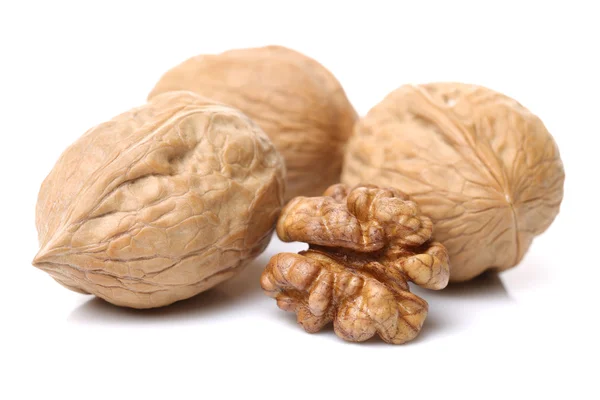 Whole and cracked walnuts with shell — Stock Photo, Image