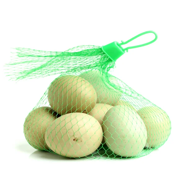 White chicken eggs in green net — Stock Photo, Image