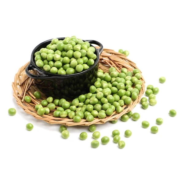 Green pea seeds on straw plate — Stock Photo, Image