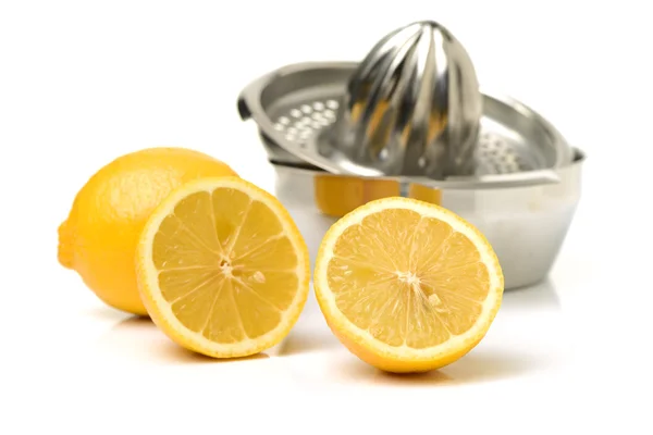 Fresh lemons with metal squeezer — Stock Photo, Image