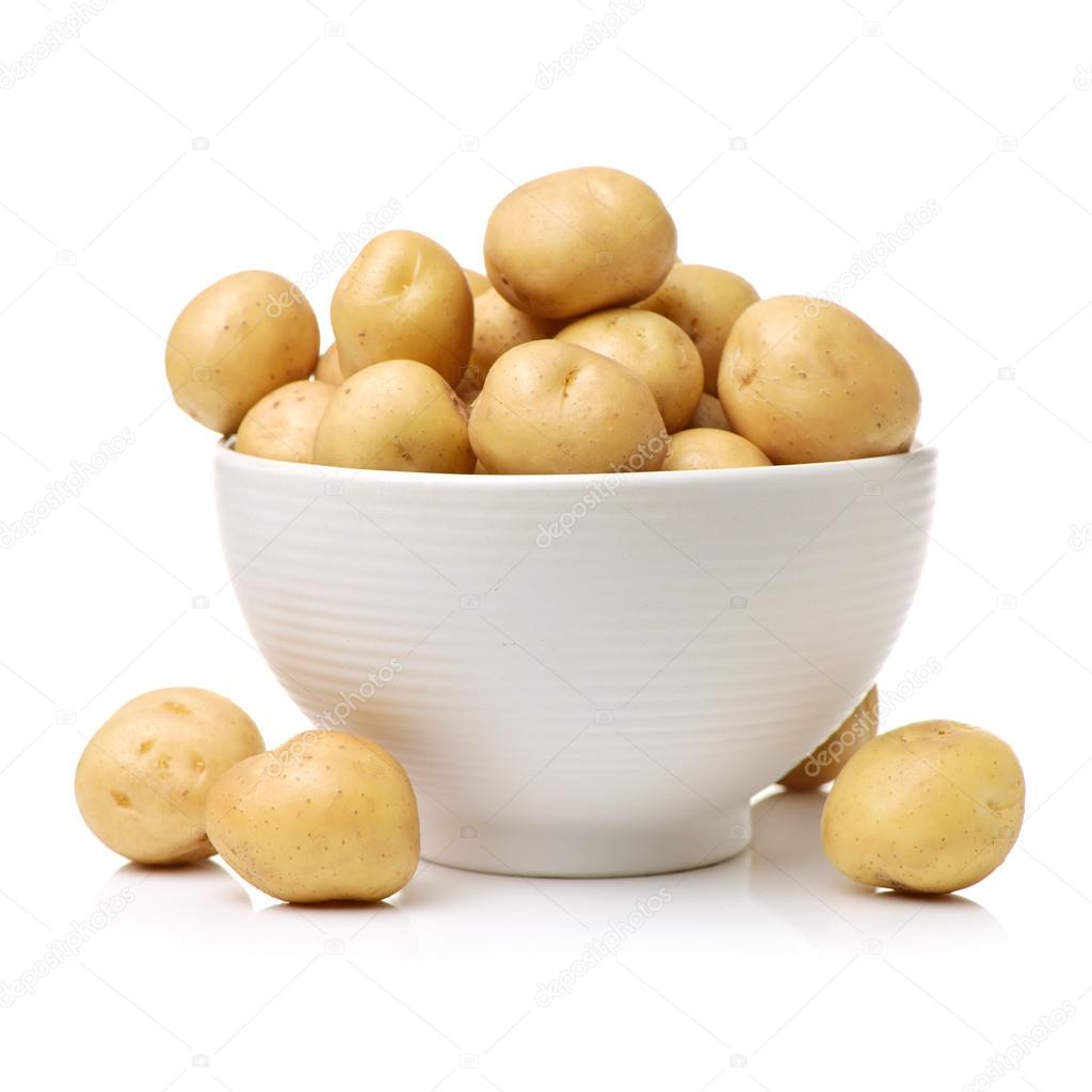 New raw potatoes in bowl