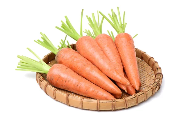 Fresh carrots on straw plate — Stock Photo, Image