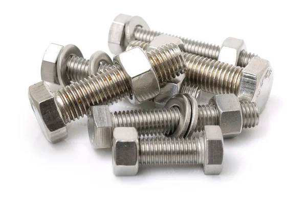 Pile of glossy bolts with nuts — Stock Photo, Image