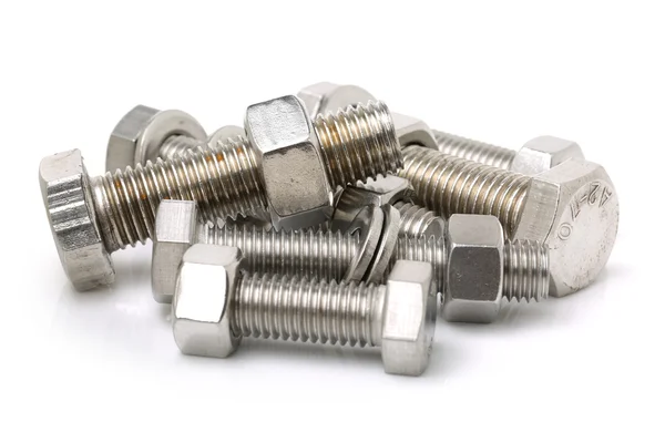 Pile of glossy bolts with nuts — Stock Photo, Image