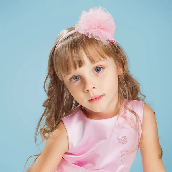 Little girl posing in a studio over colour background — Stock Photo, Image