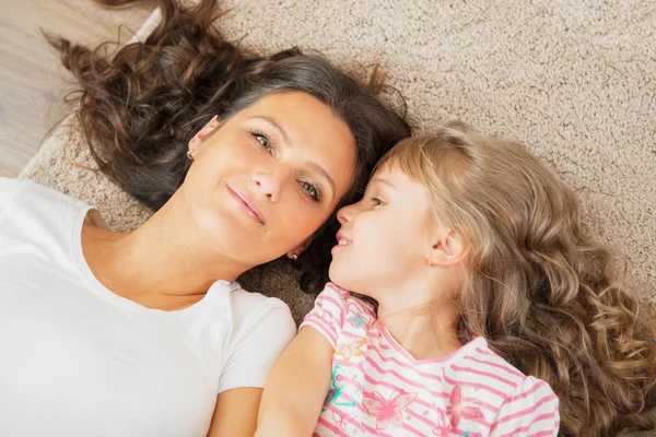 Anne ve küçük kızı beraber yalan annesinin kulağına fısıldayan