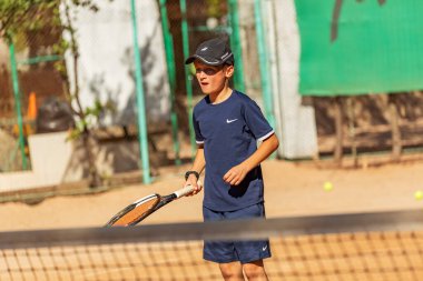 Genç tenisçi ilk yarışmalarına katılır. En zor atışları bile başarıyla yapıyor..