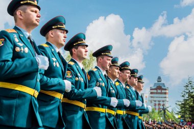 Omsk garnizonunun askerleri ve adayları Zafer Günü geçit töreninin konvoyu içinde açık sıra bekliyor..