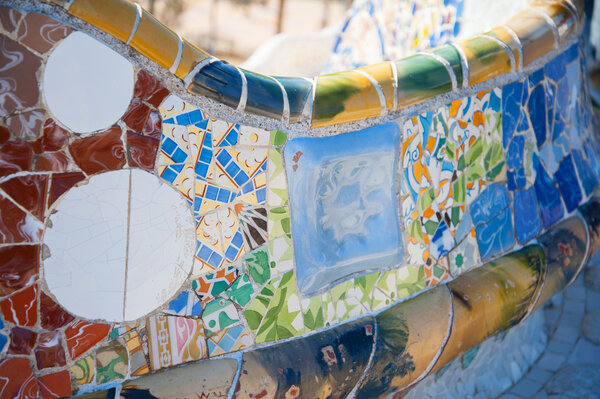Details of a colorful ceramic bench at Parc Guell designed by Antoni Gaudi, Barcelona, Spain