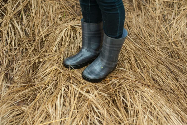 Woman feet in rubber boots