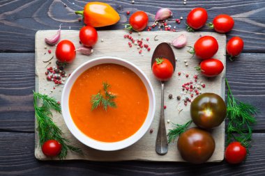 Tomato soup on a wooden table clipart