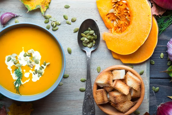 Pumpkin soup on a wooden table — Stock Image Pumpkin soup on a wooden table Stock Photo