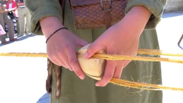 Man holding coco shell and rolling thin cords — Stock Video