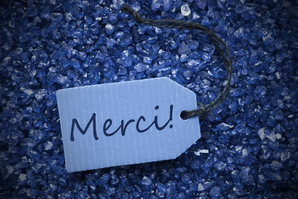 Lila stenar med etiketten Merci betyder Tack — Stockfoto