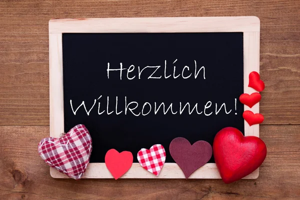 Tabule s textilním srdcem, text Willkommen znamená uvítání — Stock fotografie