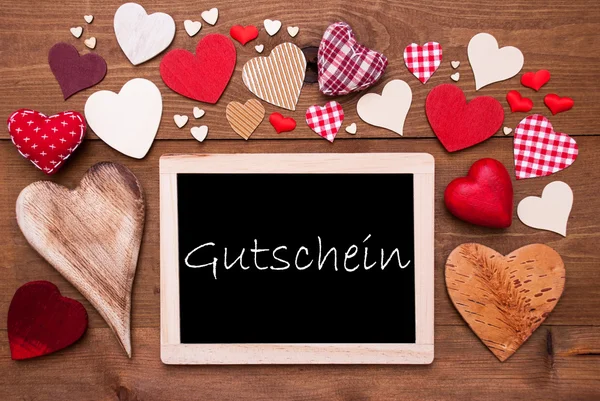 Um Chalkbord, muitos corações vermelhos, Gutschein significa voucher — Fotografia de Stock