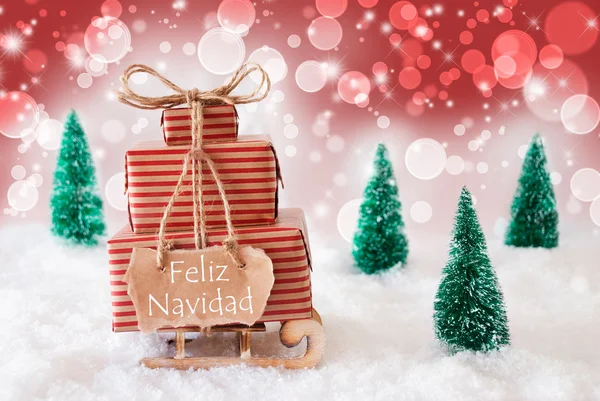 Сани на красном фоне, Фелис Навидад означает Счастливого Рождества — стоковое фото