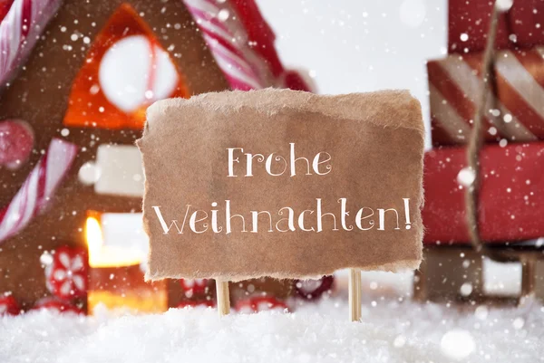 Casa de jengibre con trineo, copos de nieve, Frohe Weihnachten significa Feliz Navidad —  Fotos de Stock