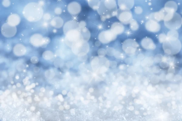 Μπλε χριστουγεννιάτικο φόντο με χιόνι, αστέρια και bokeh — Φωτογραφία Αρχείου