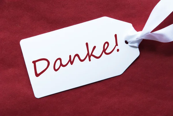 Una etichetta su sfondo rosso, Danke significa grazie — Foto Stock