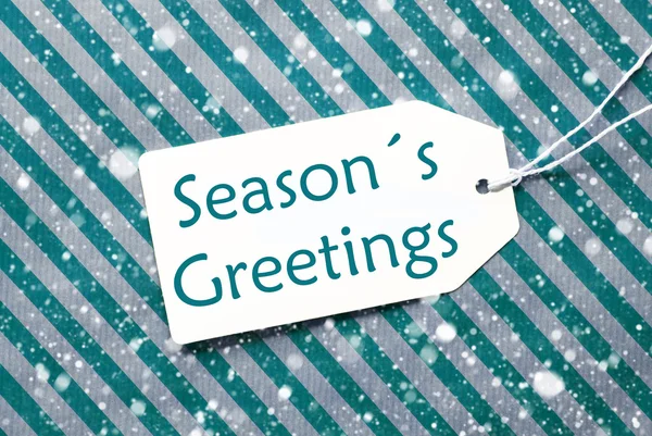 Лейбл On Turquoise Paper, Snowflakes, Text Seasons Greetings — стоковое фото
