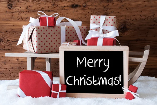 Schlitten mit Geschenken auf Schnee, Text frohe Weihnachten — Stockfoto