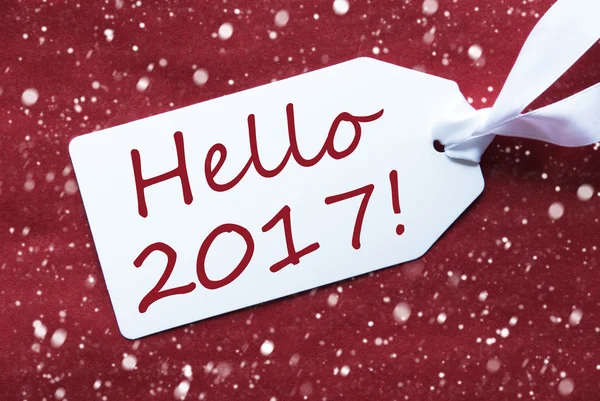 Одна етикетка на червоному фоні, сніжинки, текст Hello 2017 — стокове фото