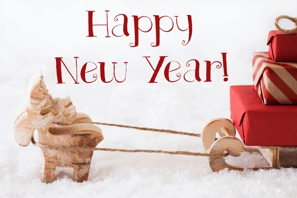 Sobi se sáňkami na sněhu, text šťastný nový rok — Stock fotografie