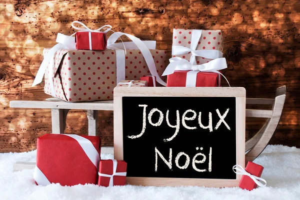 Släde med gåvor, snö, bokeh, Joyeux Noel betyder god jul — Stockfoto