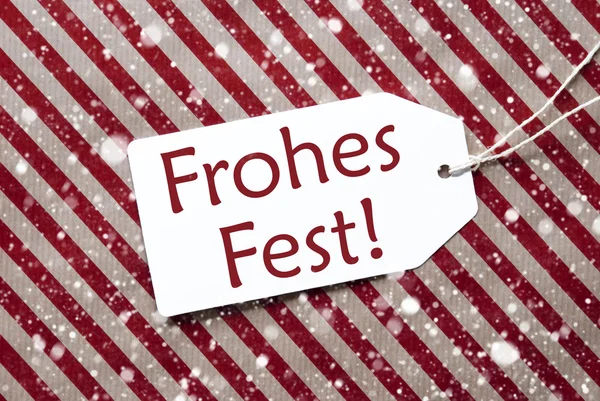 Etiket üzerindeki kırmızı kağıt, Frohes Fest mutlu Noeller anlamına gelir, kar taneleri — Stok fotoğraf