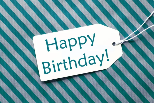 Label op Turquoise inpakpapier, tekst Happy Birthday — Stockfoto