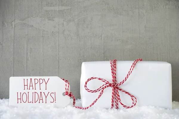Um presente, fundo de cimento urbano, texto feliz feriados — Fotografia de Stock