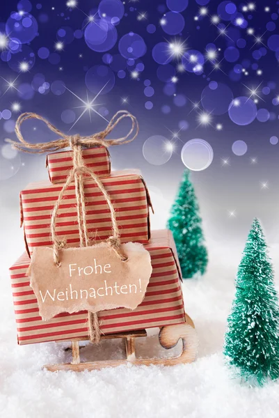 Függőleges szán, kék háttérrel, Frohe Weihnachten azt jelenti, hogy boldog karácsonyt — Stock Fotó