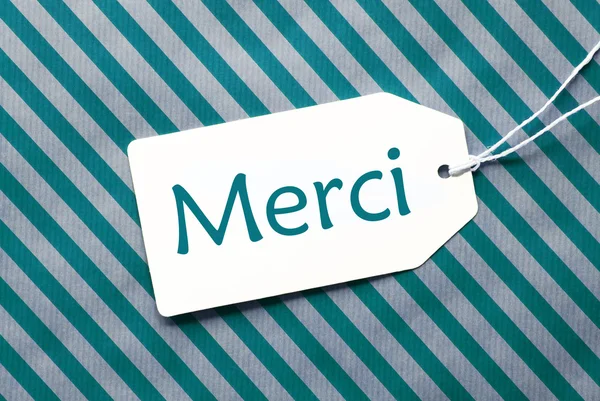 Label On Turquoise Wrapping Paper, Merci Means Thank You — Stock Photo, Image