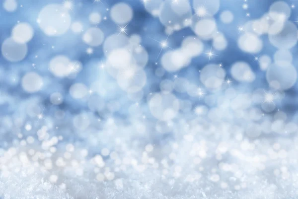 Fondo azul de Navidad con nieve, bokeh y estrellas — Foto de Stock