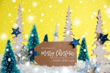 Ağaçlar, kar taneleri, sarı arka plan, etiket, mutlu Noeller ve mutlu yıllar.