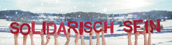 Hands Holding Word Solidarisch Sein Means Showing Solidarity, Winter Background — Stock Photo, Image