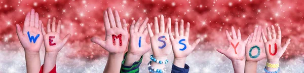 Crianças mãos construindo palavra que sentimos sua falta, fundo de Natal vermelho — Fotografia de Stock