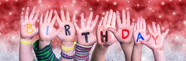 Children Hands Building Word Birthday, Red Christmas Background — Stock Photo, Image