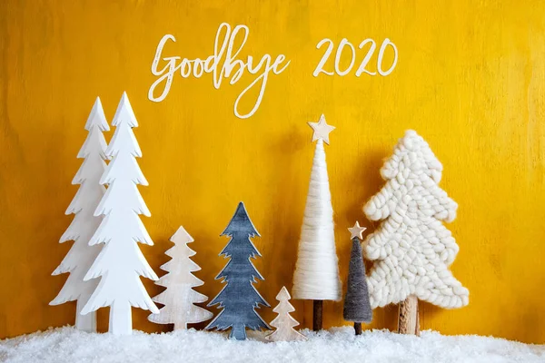 Рождественские деревья, снег, желтый деревянный фон, до свидания 2020 — стоковое фото