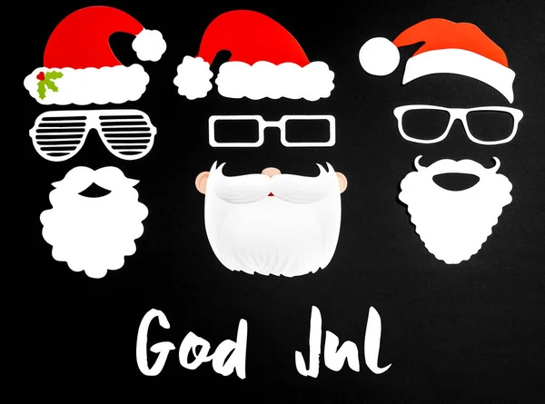 Tres Santa Claus máscara de papel, fondo negro, Dios Jul significa Feliz Navidad —  Fotos de Stock