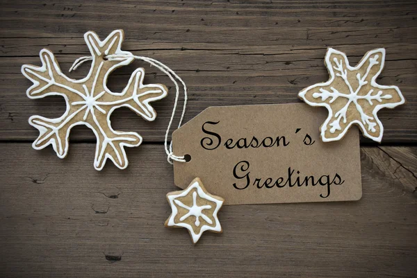 Season's Greetings on a Label with Ginger Bread Cookies — Stock Photo, Image