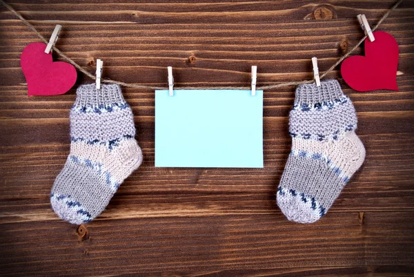 Blue Label With Baby Socks And Copy Space And Hearts — Stock Photo, Image