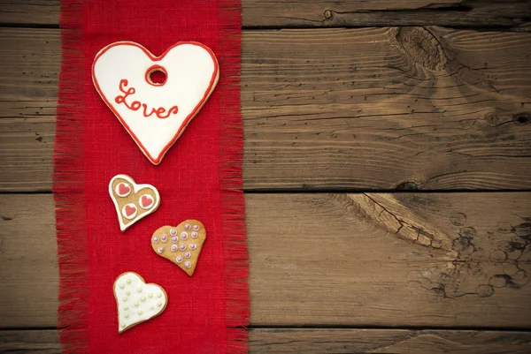 Textura de tecido vermelho com cookies de coração — Fotografia de Stock