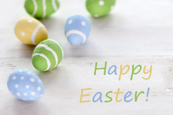 Blue Green and Yellow Easter Eggs With English Text Happy Easter — стоковое фото