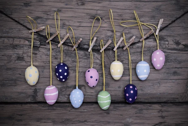 Molte uova di Pasqua colorate appese sulla linea con la struttura — Foto Stock