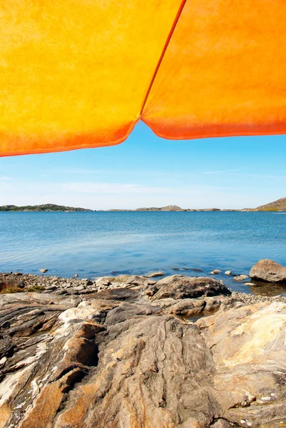 Costa sueca con parasol naranja y océano azul — Foto de Stock