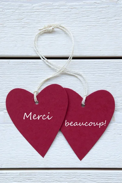Etiqueta de dois corações com francês Merci Beaucoup significa obrigado Vert — Fotografia de Stock