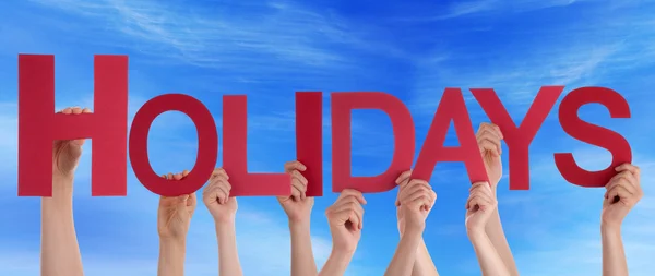 Ruce držící červená přímé slovo svátky Blue Sky — Stock fotografie