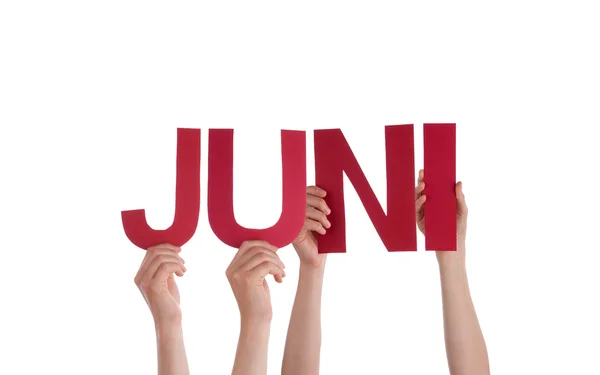 Az emberek tartsa egyenesen a német szó Juni eszközök június — Stock Fotó
